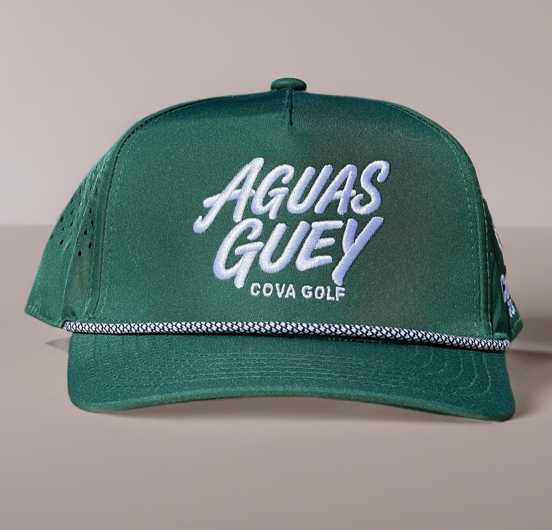 A green trucker-style cap with 'AGUAS GUEY COVA GOLF' embroidered on the front in white and light blue, shown against a neutral gray background.